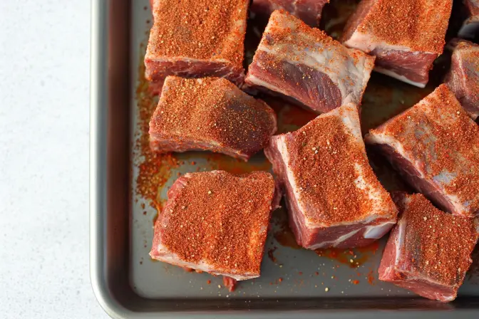Braised Mexican Style Beef Ribs: How To Get Restaurant-Level Results 10 Braised Mexican Style Beef Ribs coated in dry rub spices on a tray before cooking