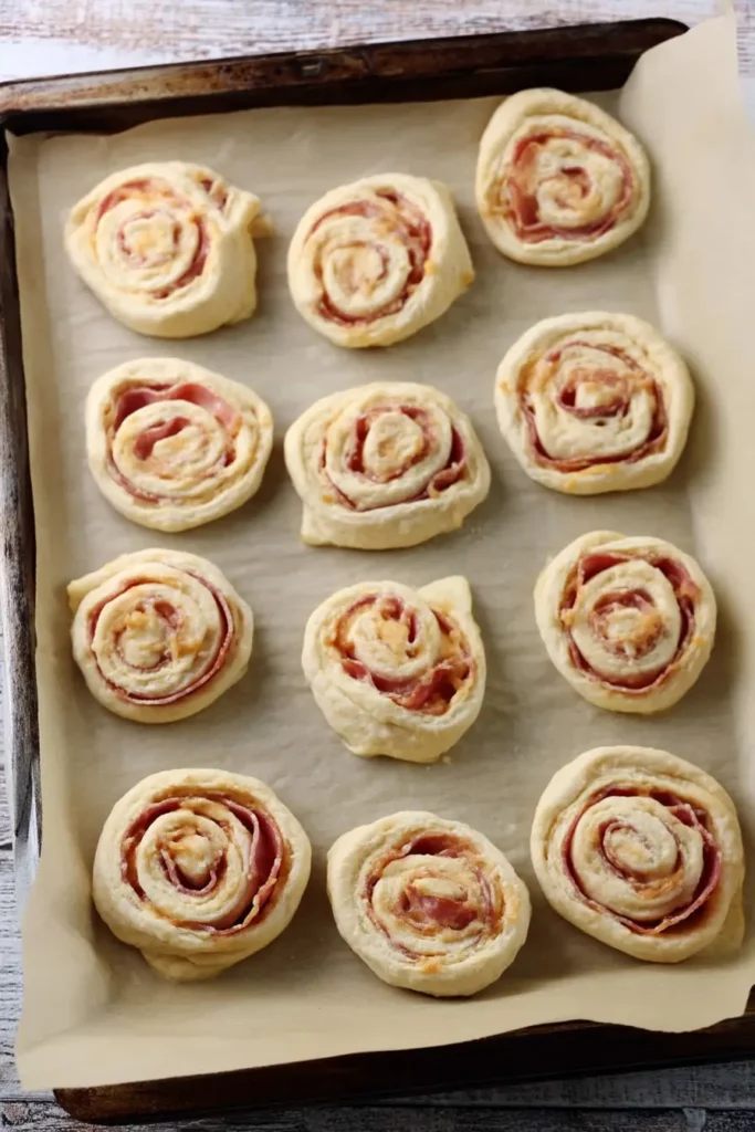 Ham And Cheese Pizza Rolls: The Truth About This Crave 5 Unbaked ham and cheese pizza rolls on baking tray
